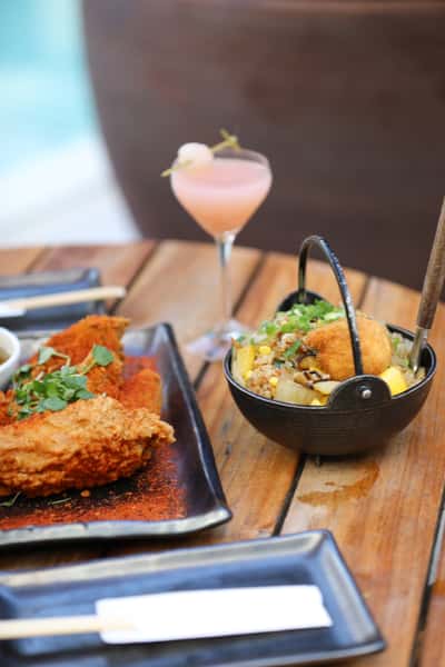 blue ribbon sushi table with cocktail, fried chicken and bowl of rice