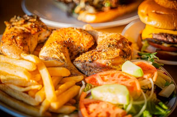 close up of chicken and fries dish