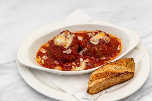 italian meatballs in marinara sauce topped with melted cheese served with toasted bread