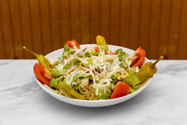 fresh italian salad with crisp greens, tomatoes, pepperoncini, and shaved parmesan cheese