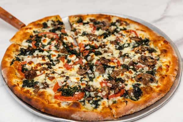 florentine pizza topped with spinach, cheese, and herbs on a thin crispy crust