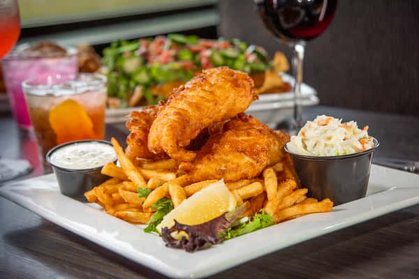 Crispy fish and chips served with coleslaw and tartar sauce