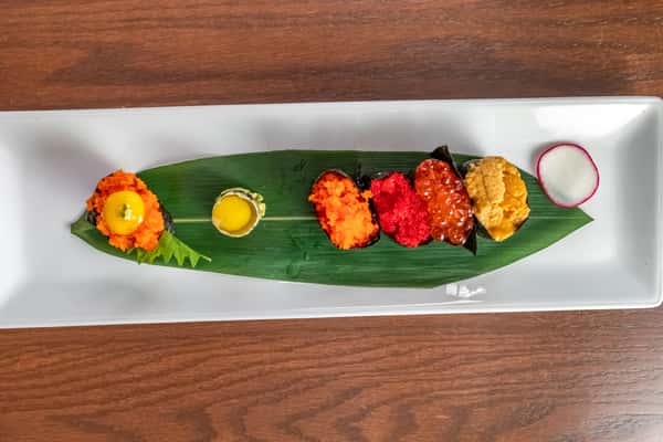 Masago Tobiko UniIkura served on a tropical leaf