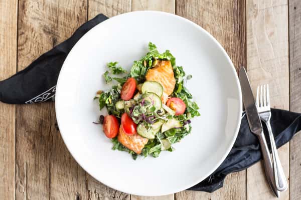 grilled salmon over tomato cucumber salad