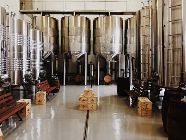 Vats of beer with boxes on the floor