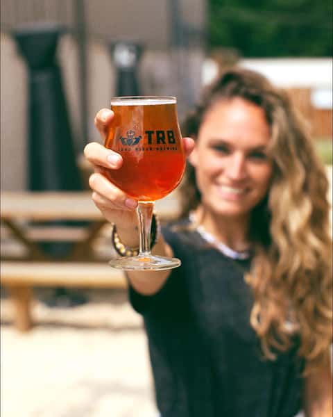 woman holding glass of beer