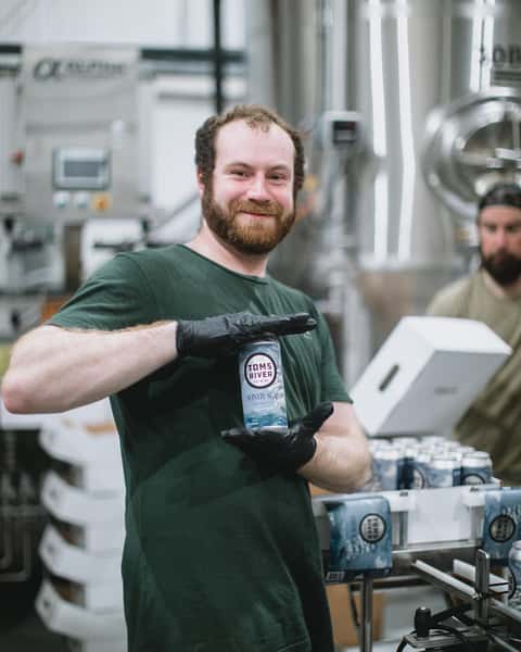 man holding can of beer