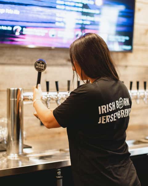 woman serving beer on tap