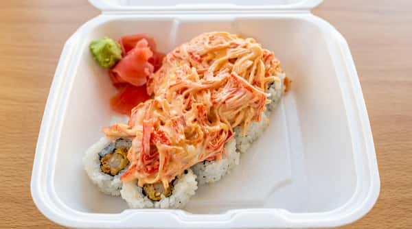 Dynamite sushi roll topped with spicy seafood mixture and creamy sauce