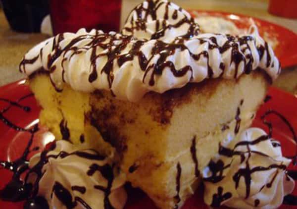 Cake topped with frosting and chocolate syrup