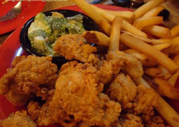 Chicken tenders with a side of french fries and broccoli.