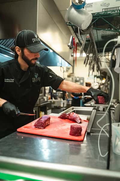 Chef Michael Butchering filet mignon in house