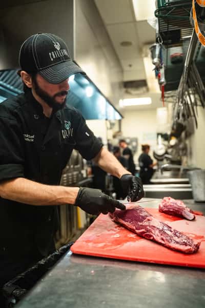 Chef Michael Butchering filet mignon in house
