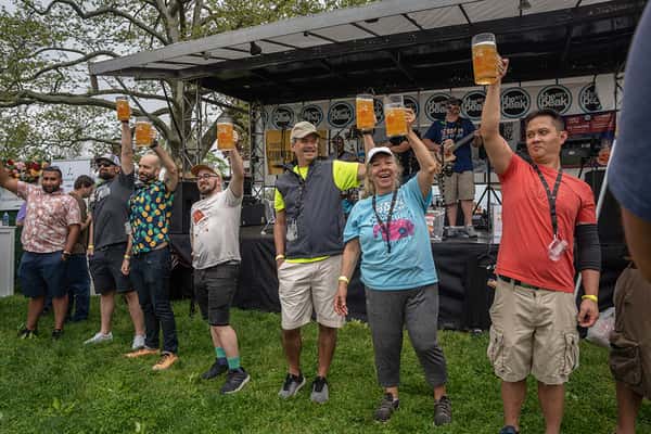 People holding up their beer