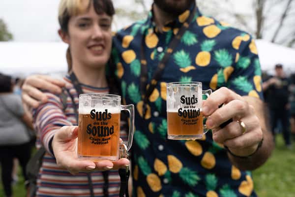 Couple holding Suds on the Sound Shotglasses