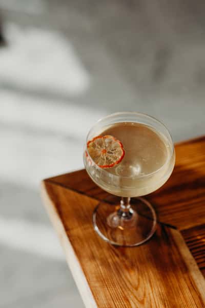 Refreshing craft cocktail garnished with fresh herbs