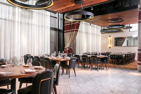 Modern European-inspired dining room with elegant lighting and contemporary decor at Ecco.