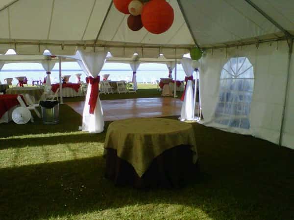 big tent with tables and dance floor under it
