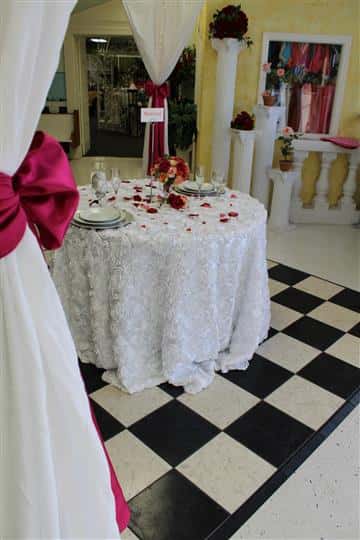 table with tablecloth and rose petals