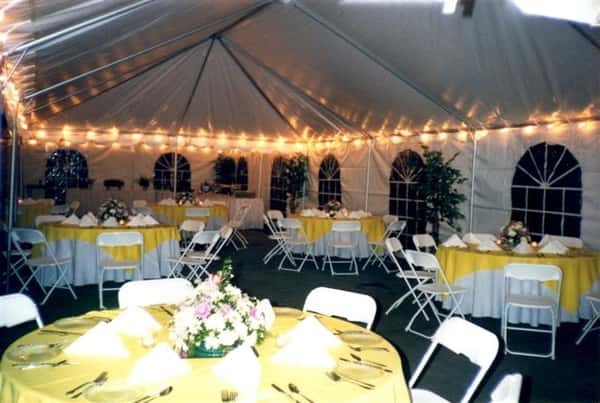 tent with lots of chairs and tables with tablecloths