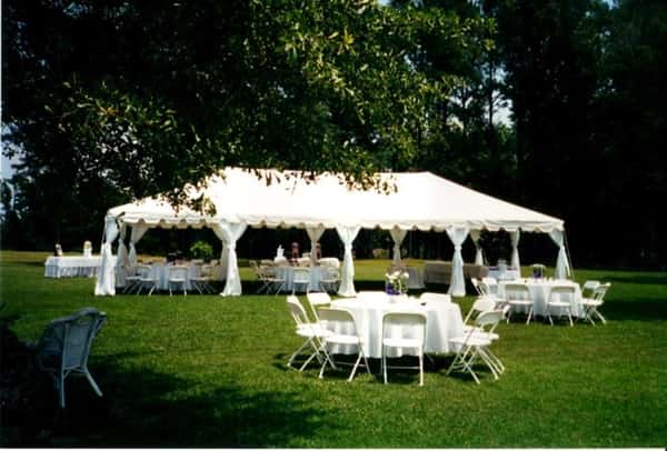 big tent outdoors with tables and chairs