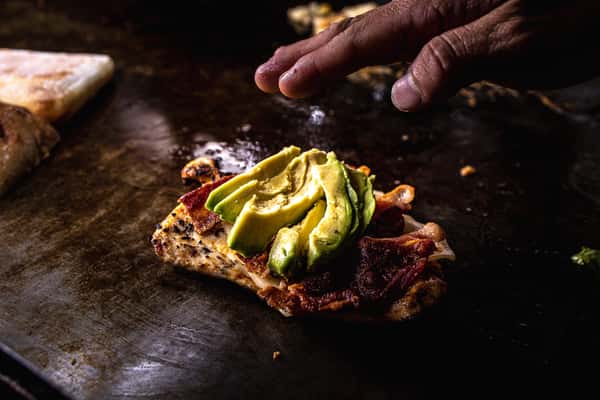 meat with avocados on grill