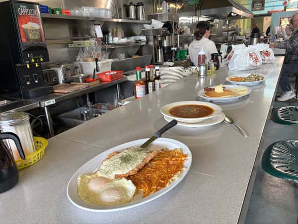 A Tennessee Grill diner counter displays several breakfast plates ready for customers.