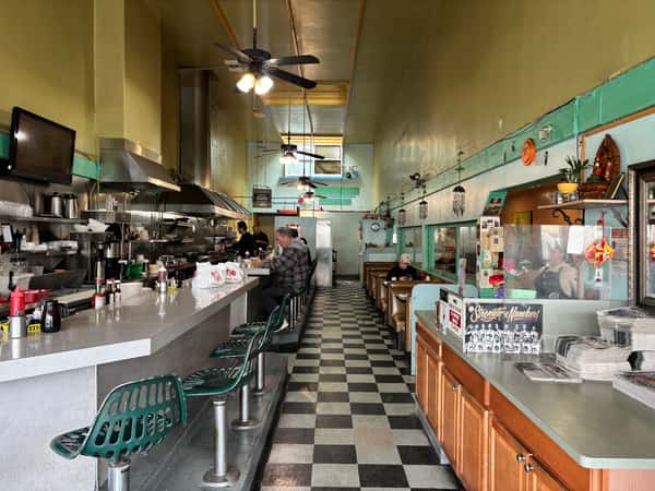 A Tennessee Grill long, narrow diner with a checkered floor and retro-style seating.