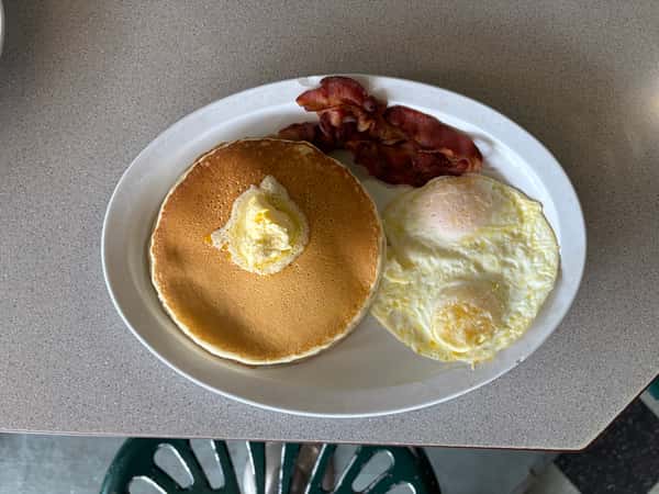A Tennessee Grill plate of pancakes, eggs, and bacon.