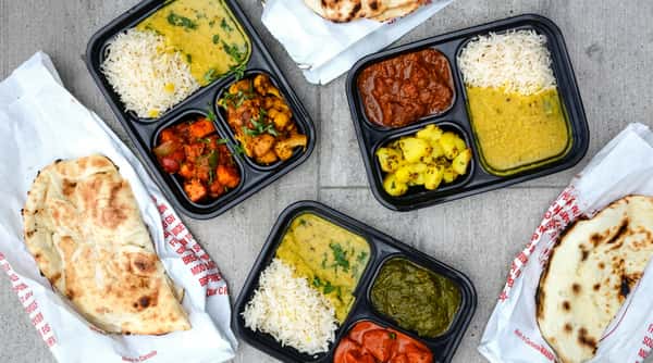 Vegetarian Indian thali meals with basmati rice, curry, dal, fresh vegetables, and naan, served at Chaat Diner, a pure vegetarian Indian restaurant in San Francisco.