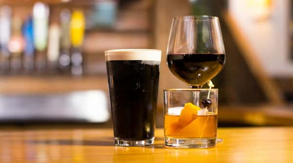 A curated selection of craft beer, red wine, and handcrafted cocktails served at the bar, highlighting our diverse beverage program.