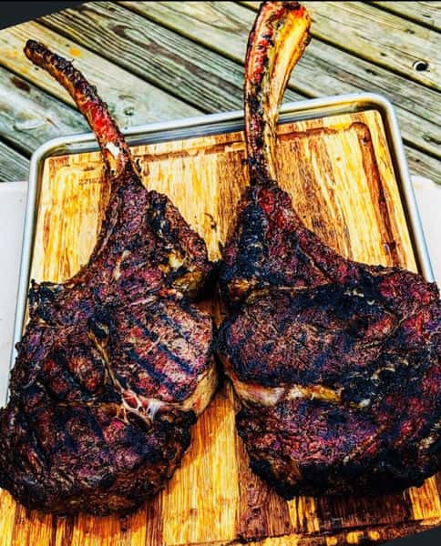 two grilled steaks on a cutting board