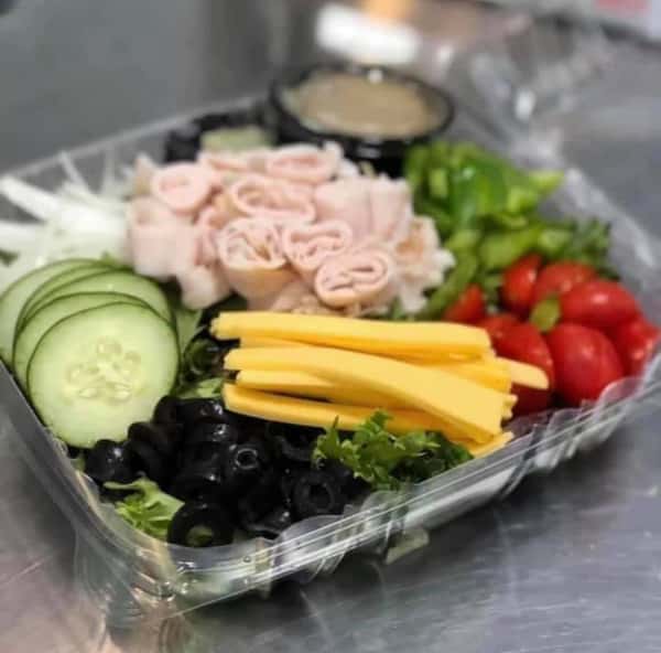 garden salad topped with turkey and dressing