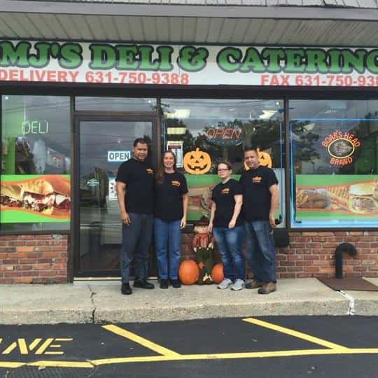 employees standing in front of mj's deli