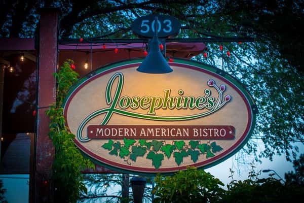 Detail sho of the sign post with the restaurant logo