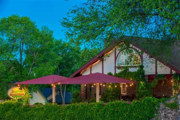 Exterior photo of the restaurant building over the bushes of the outside garden