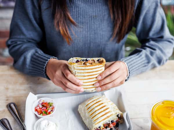 guest holding beef burrito