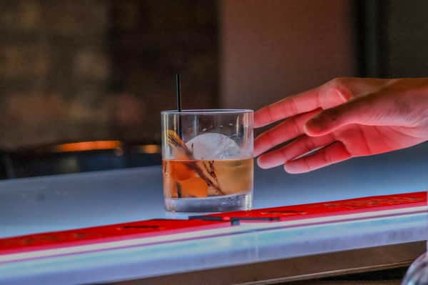 Drink with hand on glass
