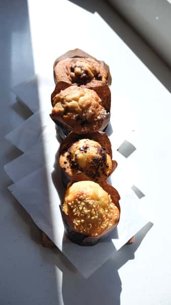 Vertical row of muffins on napkins