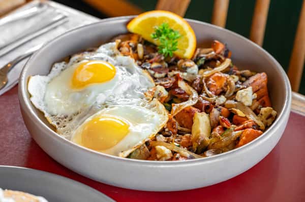 Sweet Potato Hash & Eggs brings together sweet potato hash, applewood smoked bacon, mushrooms, onion, zucchini, bleu cheese, a touch of maple syrup, and two farm-fresh eggs for a savory-sweet plate with serious depth 🍳🍠 Stop by Hobee's Restaurant and try Sweet Potato Hash & Eggs today. #HobeesRestaurant #SweetPotatoHashAndEggs #BreakfastFavorites