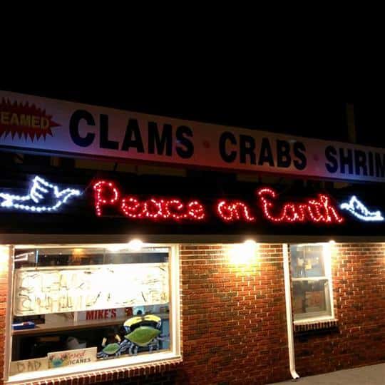 a christmas "peace on earth" LED sign on the storefront
