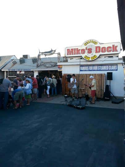 a line out the door of customers outside of mike's seafood