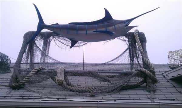 closeup of the swordfish statue on the roof of mike's seafood