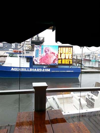 a billboard on a boat that says "Summer love at mike's"