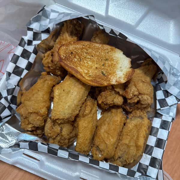 Basket of fried chicken with a slice of bread