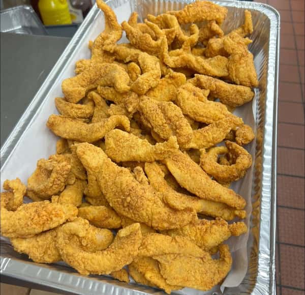 Large catering tray filled with fried fish fillets