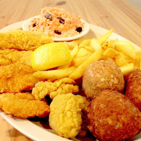 Fried seafood platter with hush puppies, fried fish, and fried shrimp
