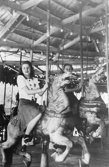 Vintage photo of a carousel with two girls on it