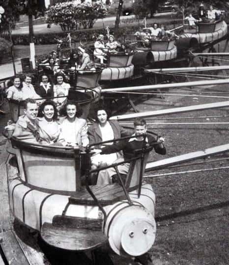 Vintage Photo of an old amusment park ride with people enjoying it