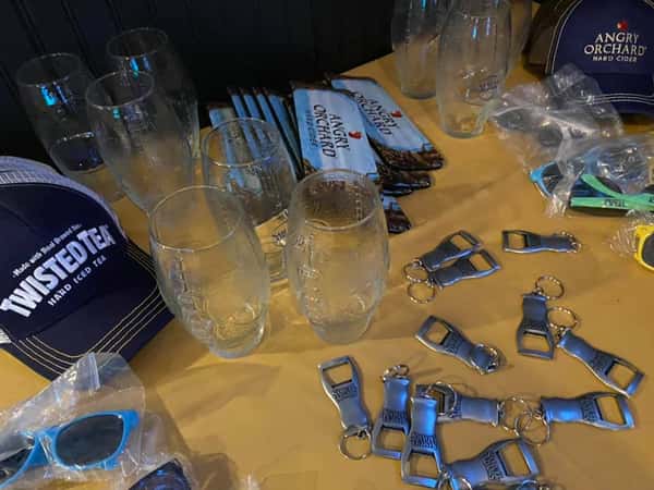 Angry Orchard and Twisted Tea merchandise on a table at a catered event